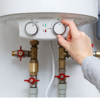 HVAC technician installing a smart thermostat on the wall.