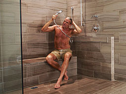 A man showering using a detachable showerhead