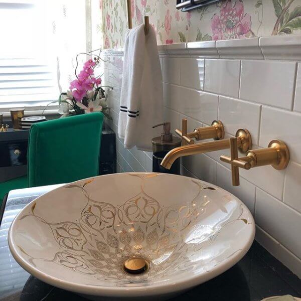 An ornate gold and white bathroom sink