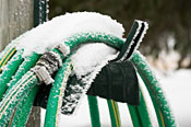 A garden hose covered in snow