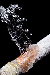 A burst, frozen pipe spraying water