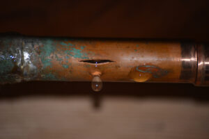 Burst copper pipe with some corrosion, dripping water