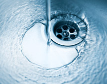 Water flowing down stainless steel sink drain