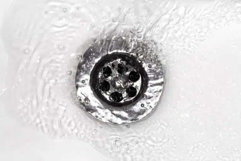 water flows into a sink in a white sink, a close-up photo