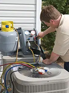 HVAC technician fixing air conditioner condenser unit