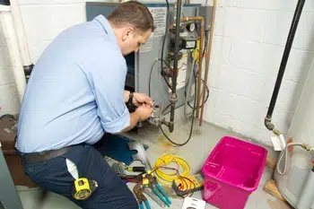 An HVAC technician repairing a furnace