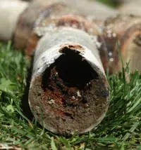 clogged sewer line cut open
